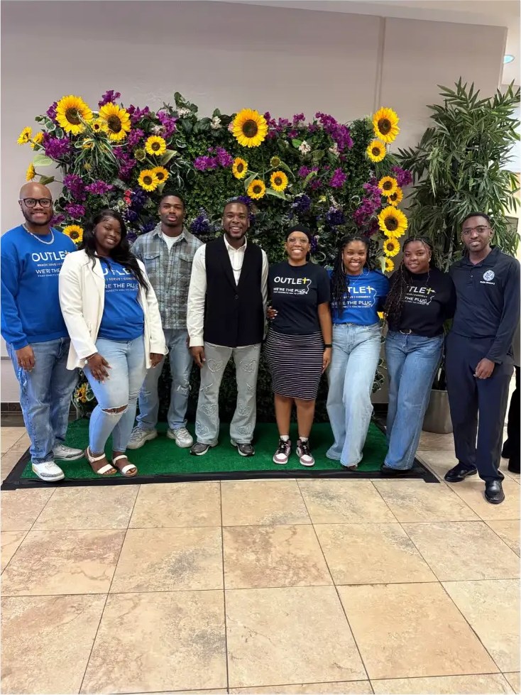 Outlet members together at church in Outlet shirts